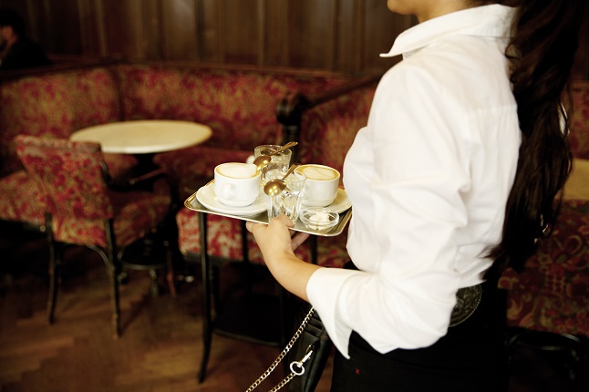 Waitress carrying coffees in a Vienna cafe