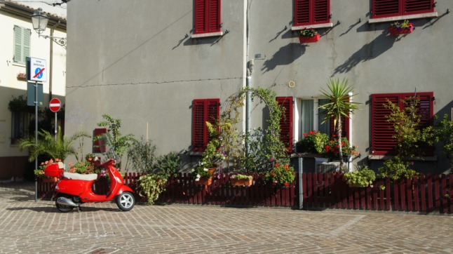 A vespa outside an Italian house.