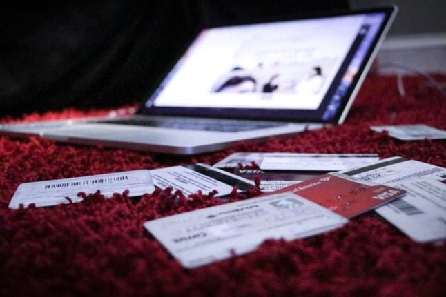 Credit cards laid out next to an open laptop