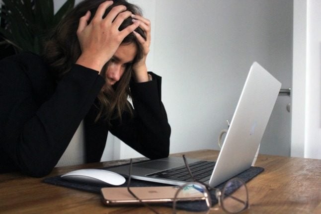 Pictured is a women having computer troubles