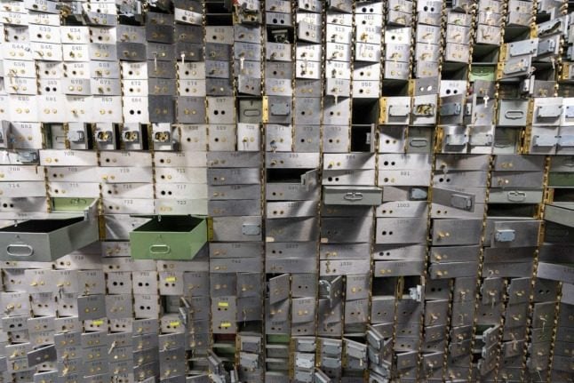 A wall of open safety deposit boxes