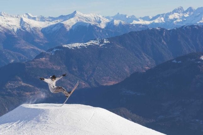 A skier pulling off a funky trick in the Swiss ski field of Laax.