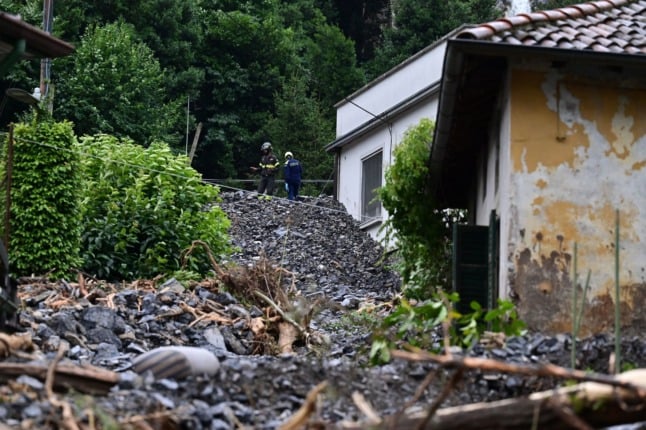 Firefightersinspect damages caused by a landslide in Laglio, on July 28, 2021, after heavy rain caused floods in towns surrounding Lake Como in northern Italy. 
