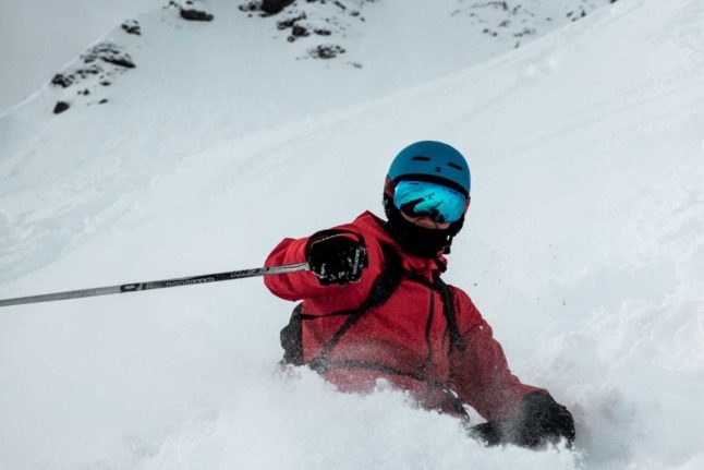 A skier carves up some sweet pow pow in the Swiss alps.