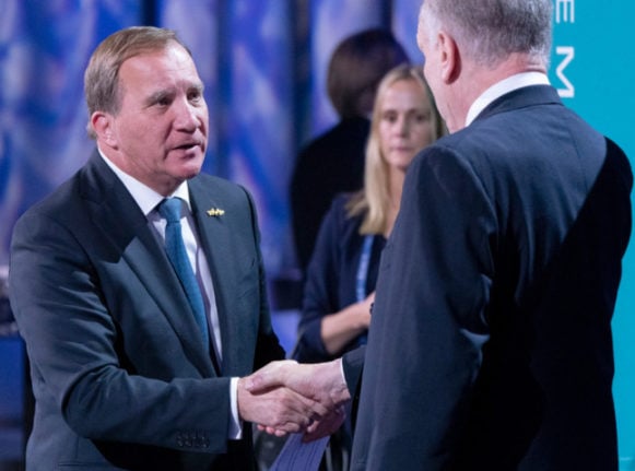 Löfven shaking hands with Ronald S Lauder, president of the World Jewish Congress.