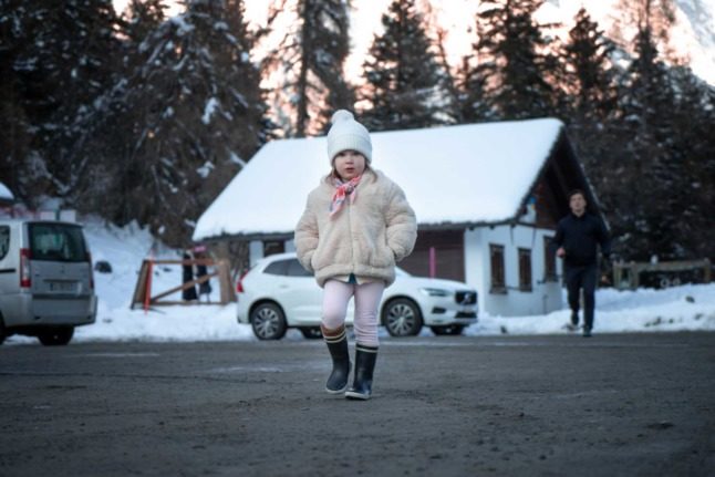 A girl in the Swiss canton of Valais looks at the camera