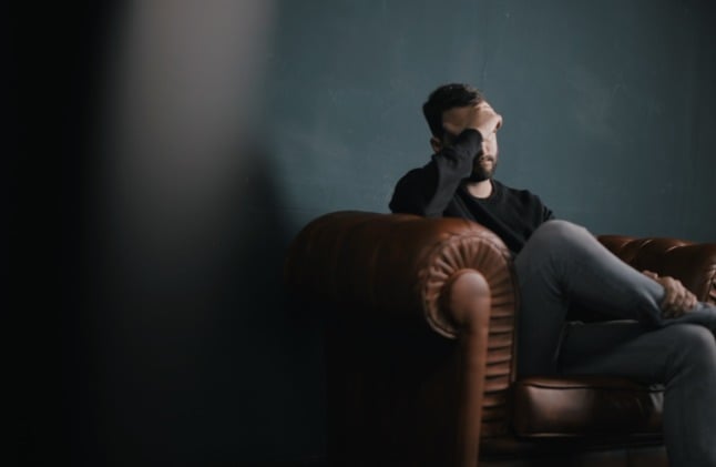 A man sits depressed during a mental health consultation. The Covid-19 pandemic has put us all under mental strain.