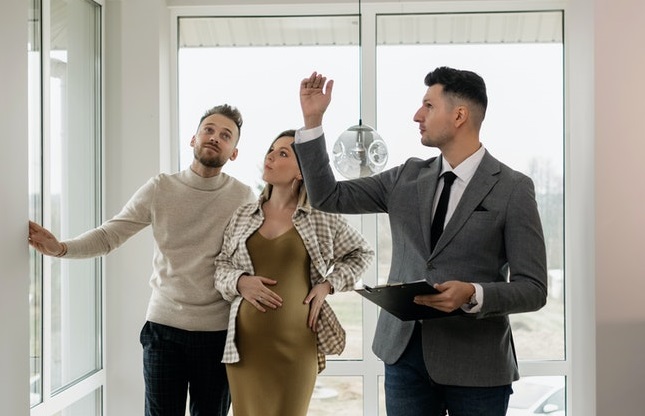 Couple and estate agent looking at an apartment