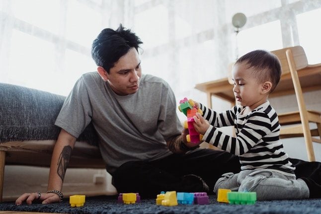 Man and child playing with building blocks