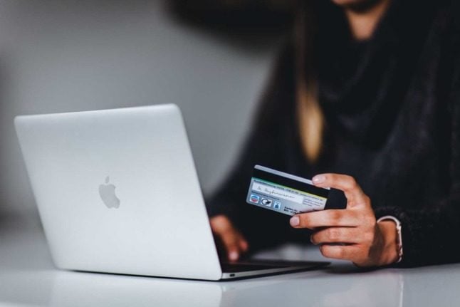 A woman uses her card to buy something online
