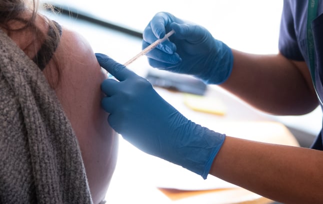 a woman getting the covid-19 vaccine