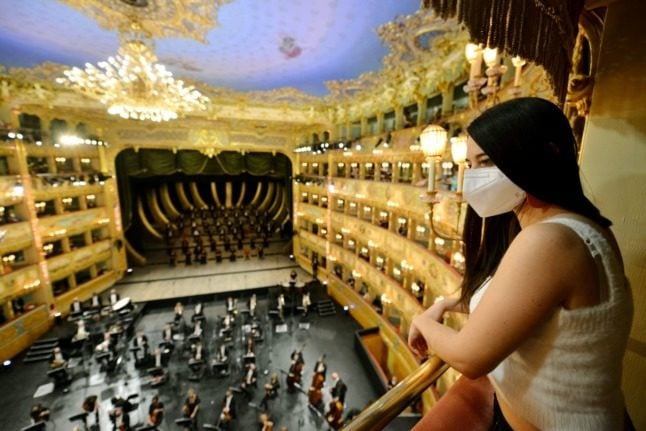 A spectator attends the performance of “Verdi e la Fenice” at the reopening of the Fenice Opera theatre in Venice on April 26, 2021. 