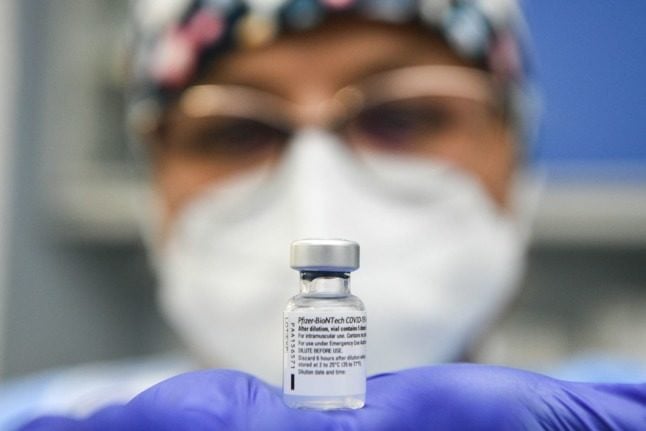 A health worker holds a vial of the Pfizer-BioNTech Covid-19 vaccine at the Cremona hospital in Cremona, Lombardy, on December 27, 2020. 