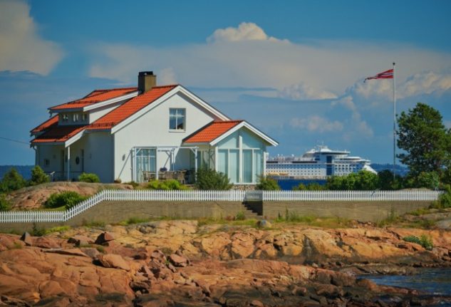 Ever wondered how straightforward it is for a foreigner to get a mortgage. Pictured is a typical Norwegian coastal house with a cruise ship sailing past in the background