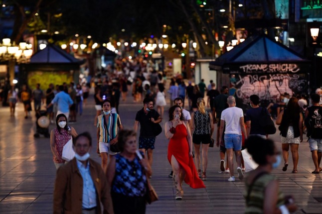 people walk without masks on ramblas barcelona during covid times 