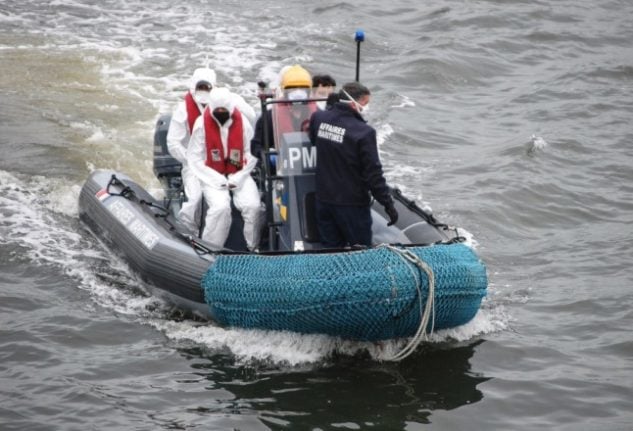 A dinghy belonging to the French Maritime Affairs department heads for shore, carrying several migrants who had tried to cross the Channel to England