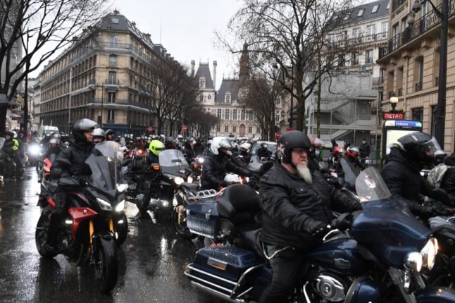 A street in Paris filled with motorbike riders protesting against parking charges for two-wheeled motor vehicles in the capital