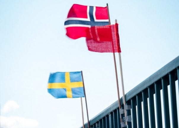 A Swedish flag on the Swedish side of the border and a Norwegian one on the Norwegian side. 