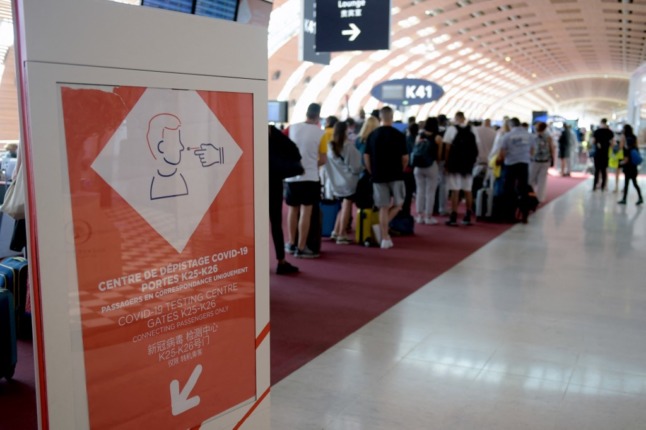 A sign guides passengers to a Covid-19 testing center in Paris Charles de Gaulle airport. Non-vaccinated passengers seeking to enter France face tougher restrictions.