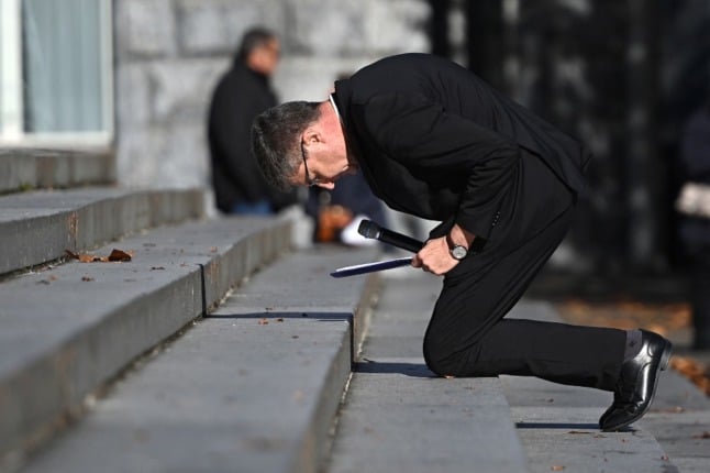 Archibshop of Reims Eric de Moulins-Beaufort kneels as a sign of penance during a ceremony at the sanctuary of Lourdes.