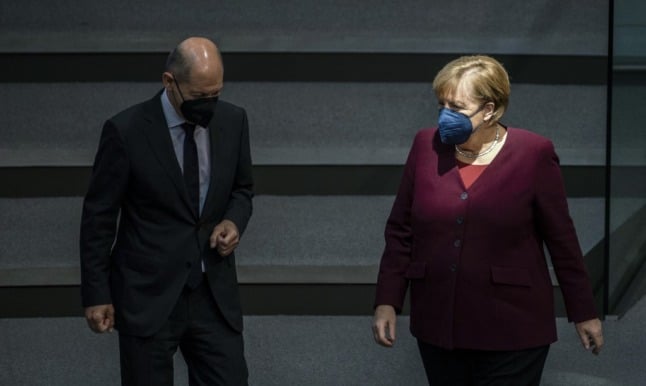 German Chancellor Angela Merkel and German Finance Minister and chancellor candidate Olaf Scholz confer during a session at the Bundestag