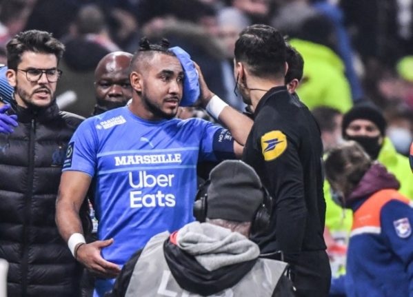 Marseille midfielder, Dimitri Payet, leaves the field after being injured by a projectile. The French authorities are pushing for a crackdown on football violence.