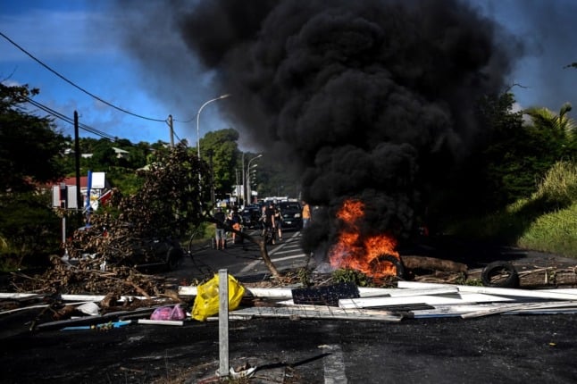 Burning cars and roadblocks in Guadeloupe. 