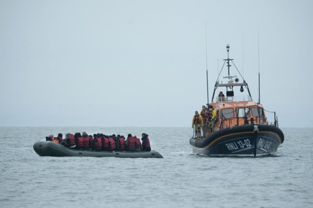 The British RNLI help an overloaded small boat in the Ebglish Channel. 