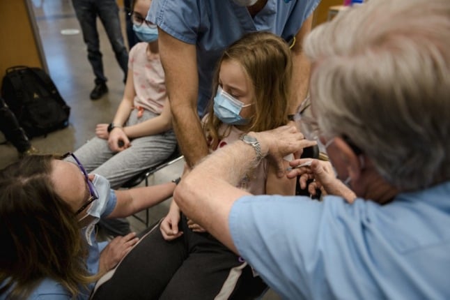 A child, age 8, receives the Pfizer-BioNTech Covid-19 vaccine  