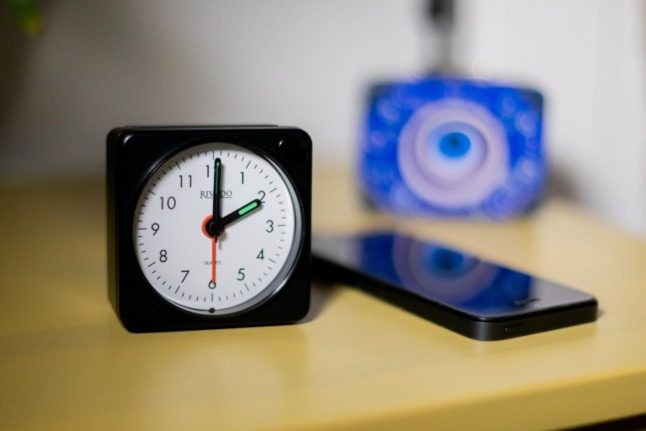 An alarm clock lies on a table. 