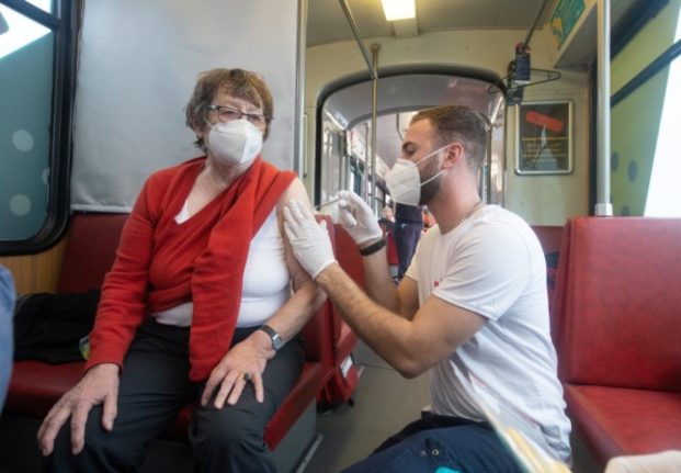 A woman gets a booster jab on the 'vaccination tram' in Frankfurt.