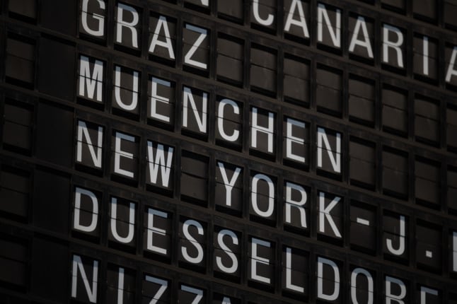 Destinations are pictured on an airport departures board