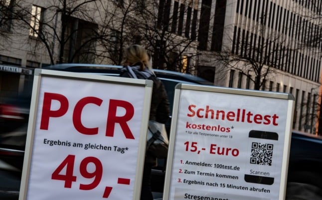 A test centre in Berlin shows the costs for a rapid and PCR test.