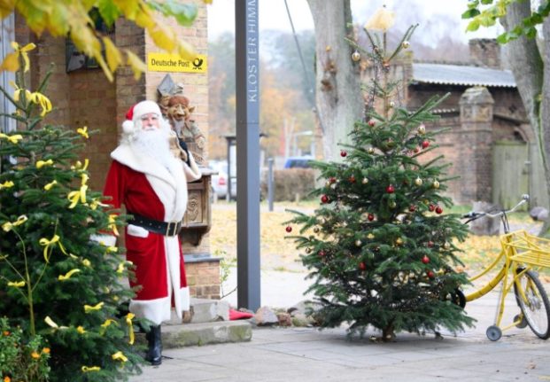 Santa comes out for a short break after arriving at the Christmas Post Office in Brandenburg. 