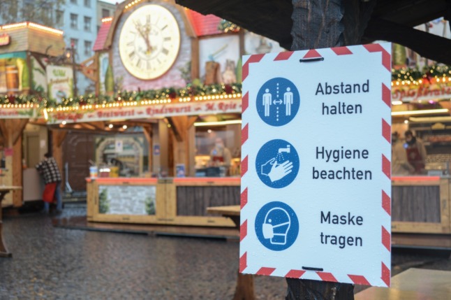 A sign for Covid rules at a Christmas market in Frankfurt.