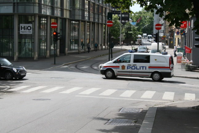 Police rammed the attacker with their car before he was shot. Pictured is a police van driving through Oslo