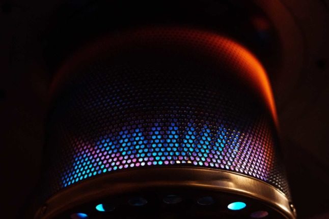 The blue, yellow and red flames of a gas heater up close
