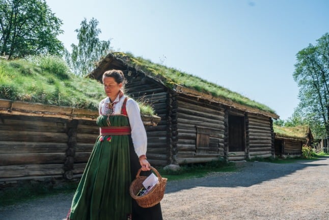 Pictured is a woman in a bunad at the Norwegian Folk Museum. 