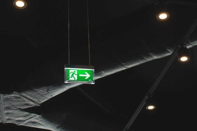 A green exit sign at Vienna International Airport
