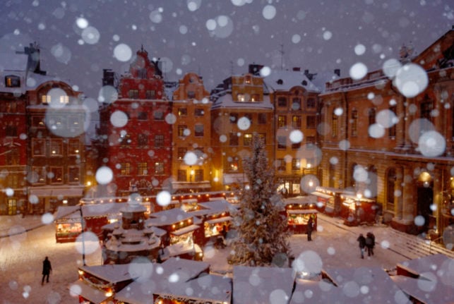 snow on stockholm's gamla stan christmas market