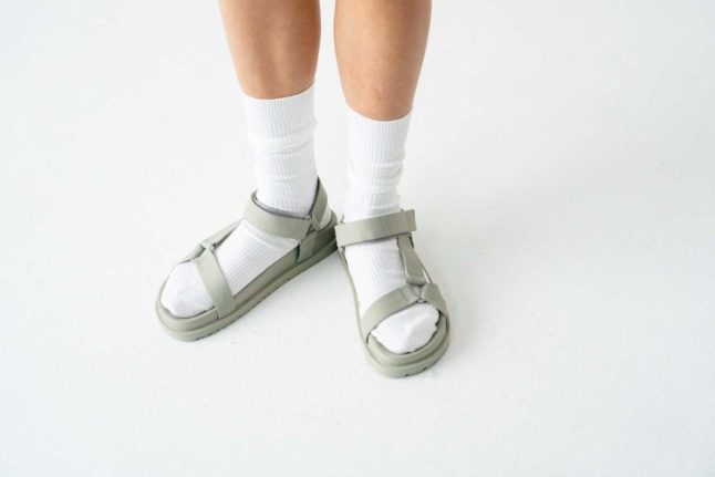 A person wearing socks with sandals