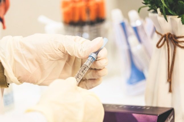 Here's how you can get the flu-jab in Norway. Pictured is a doctor preparing an injection,