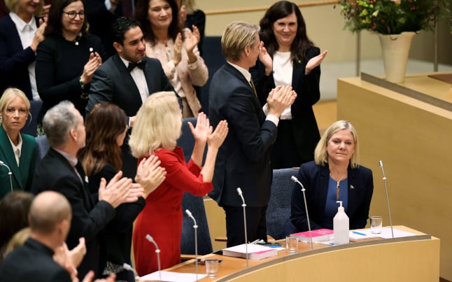 magdalena andersson surrounded by applauding party colleagues