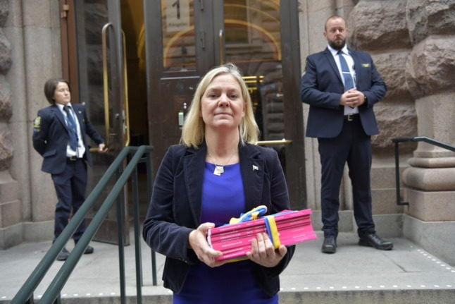 magdalena andersson outside parliament holding the 2022 budget