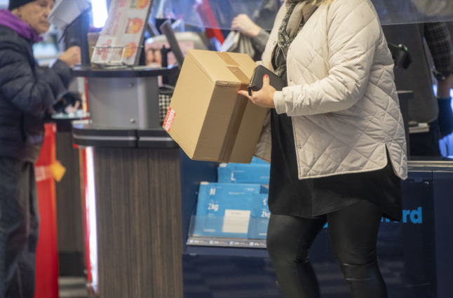 a woman collecting a parcel from an ICA supermarket