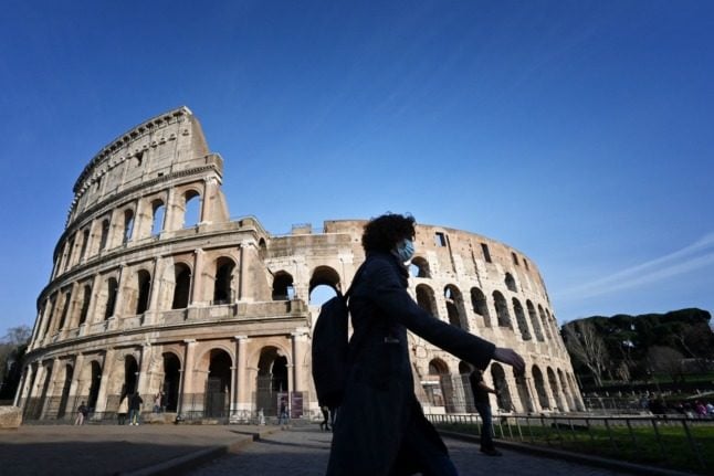 A tourist walks past the closed Colosseum on March 10, 2020. 