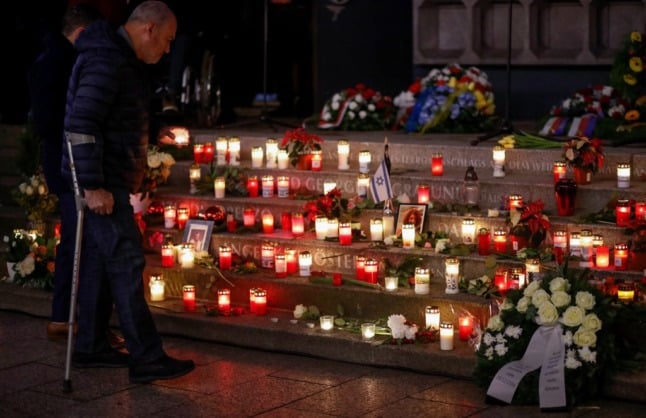 Candles and flowers laid by people to commemorate the victims of the 2016 attack at Breitscheidplatz Christmas market in Berlin