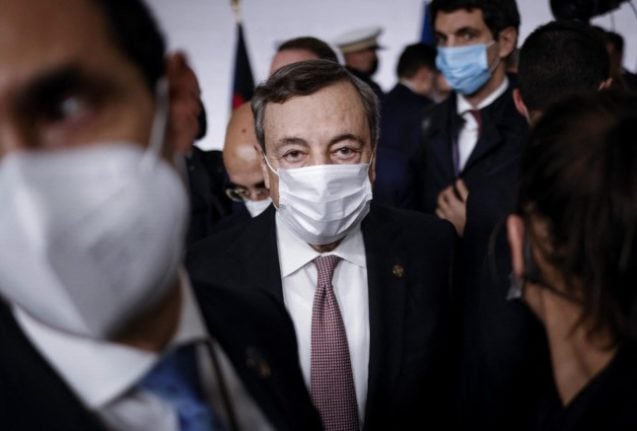 Italian Prime Minister Mario Draghi leaves after a press conference 