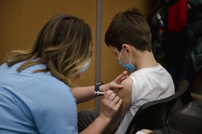 A child, 11, receives the Pfizer-BioNTech Covid-19 vaccine for children 