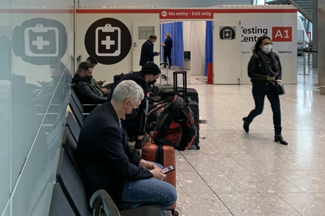 Passengers wait at an airport.